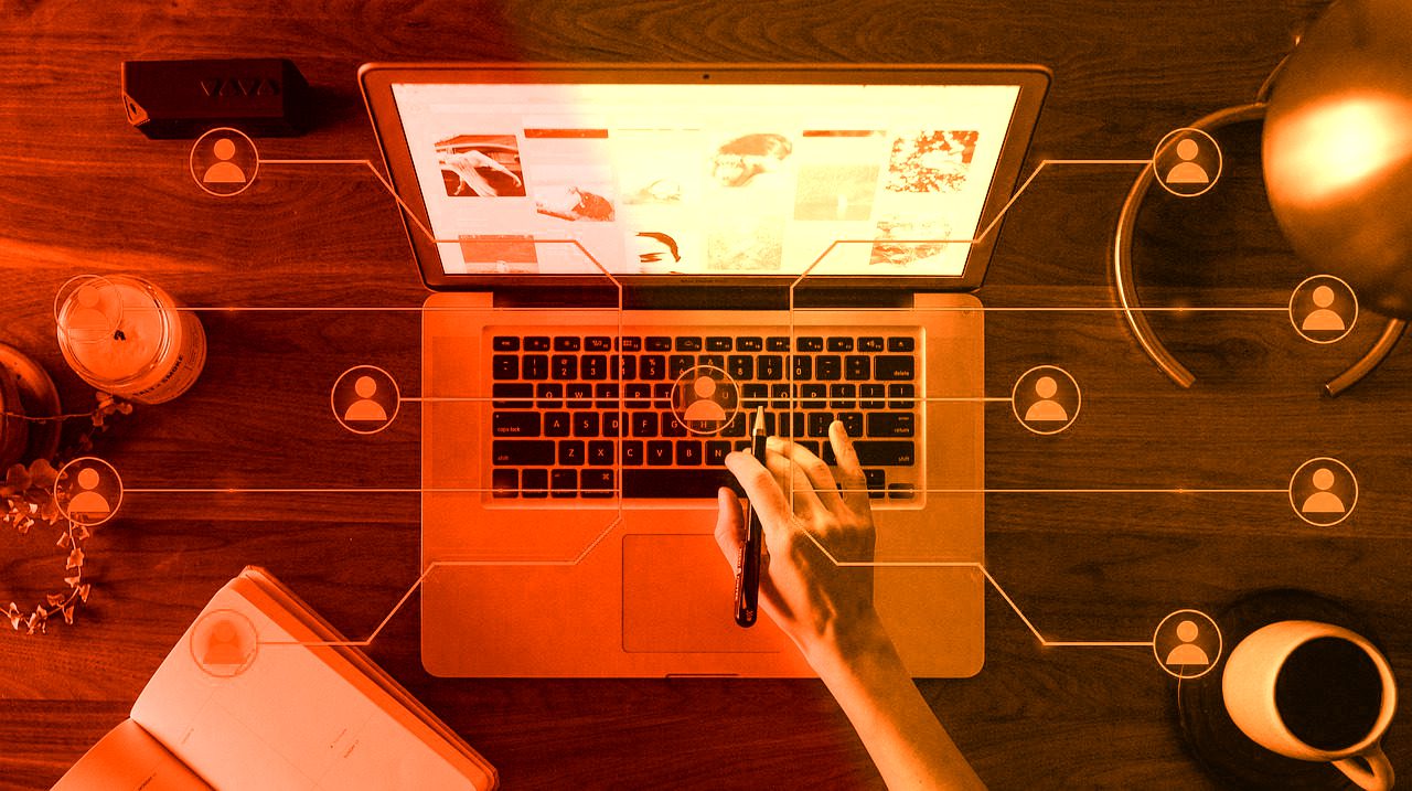 Hands working on laptop with digital marketing